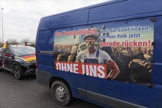 Poster criticising the government on a van, budget deficit, farmers' protests, demonstration