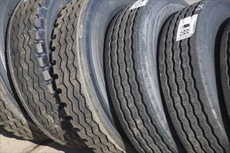 Range of large vehicle tyres leaning against each other