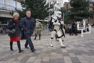 People walk past carnies in Star Wars costumes on a shopping street in Liverpool, 02/03/2019