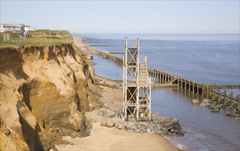 Former beach access stairs now stand alone as coastal erosion continues, Happisburgh, Norfolk,