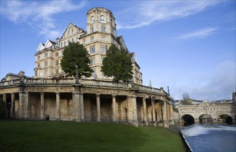 The former Empire Hotel, River Avon and Pulteney Bridge from Parade Gardens, Bath, Somerset,