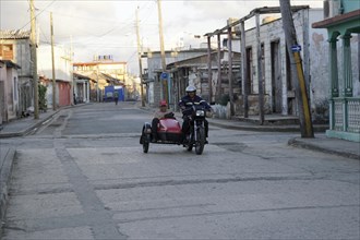Motorbike with sidecar on the road in Baracao, Cuba, Central America