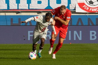 Football match, Jeremine FRIMPONG Bayer Leverkusen left in duel with Jonas FOeHRENBACH 1.FC
