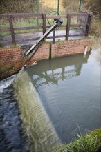 Whitebridge weir on the River Deben, Campsea Ashe, Suffolk England is a simple mechanical device to