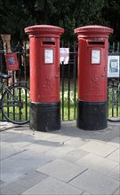 Two old traditional red pillar boxes in the street, Cambridge, England, United Kingdom, Europe