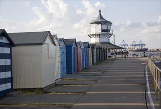 Colourful seaside beach huts and Low lighthouse maritime museum, Harwich, Essex, England, United