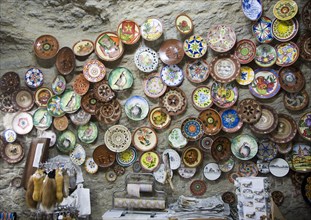 Ceramic plates on display on wall of cave shop Setenil de las Bodegas, Cadiz province, Spain,