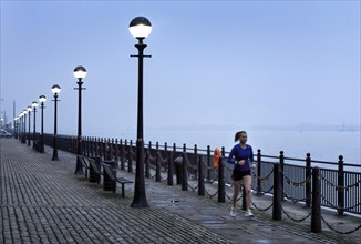A woman jogs in the morning near the Royal Albert Dock, Liverpool, 01/03/2019