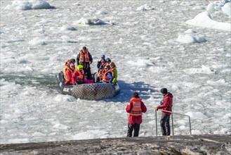Passengers on the Stella Australis cruise ship travelling through ice floes to Pia Glacier, Alberto