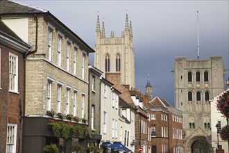 Tower of Saint Edmundsbury Cathedral above a street of historic buildings, Bury St Edmunds,