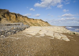 Coastal defences normally covered by shingle exposed by winter storms at Thorpeness, Suffolk,