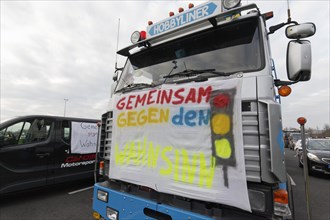 Together against the madness of traffic lights, banner on a truck, farmers' protests, demonstration