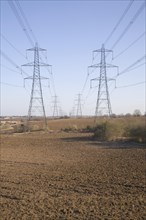 Electricity pylons and transmission lines cross countryside, Claydon, Suffolk, England, United