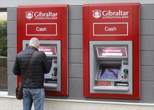 A man withdraws money from a Gibraltar International Bank ATM in Gibraltar, 14/02/2019