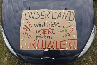 Sign criticising the government on a car, farmers' protests, demonstration against policies of the