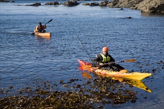 Two men fishing from kayak canoes off Lizard Point, Cornwall, England, United Kingdom, Europe