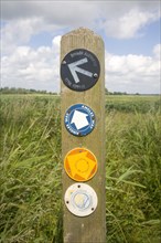 Route markers for Angles Way long distance footpath in marshes near Oulton Broad, Suffolk, England,