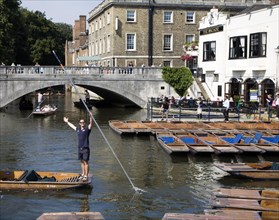 People punting in small boats on the River Cam near Silver Street Bridge, Cambridge, England,