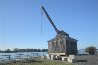 Historic wine loading crane from 1746 with cargo, suitcase and wine barrel on the Rhine, landmark,