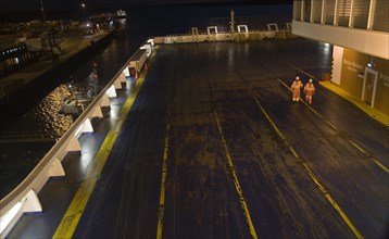 Two seaman walking on cargo deck of Stena night ferry, Harwich, Essex, England, United Kingdom,