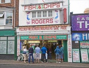 Rogers famous fish and chips shop with queue of people, Great Yarmouth, Norfolk, England, United