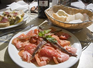 Tomato anchovy salad meal on table, Ronda, Spain, Europe