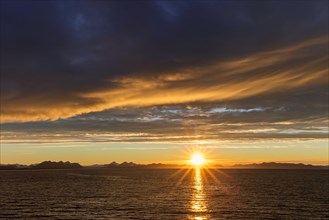 Sun setting on a rainy evening over Isfjorden, Isfjord in summer at sunset, Spitsbergen, Svalbard,