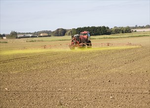 Farm machinery spraying Glyphosate herbicide on an arable field near Hollesley, Suffolk, England,
