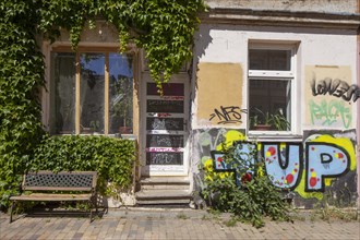 Colourfully smeared old house entrance in the Kroepeliner-Tor-Vorstadt, Rostock,