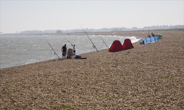 People sea fishing from beach, Hollesley Bay, Shingle Street, Suffolk, England, United Kingdom,