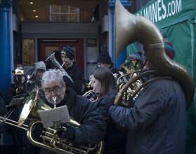 Brass band musicians perform at Christmas street fair, Woodbridge, Suffolk, England, United