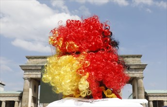 Football fan wears a wig with the colours of the German flag for the World Cup opening match