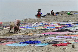 Washing clothes in the Irrawaddy, Myanmar, Asia