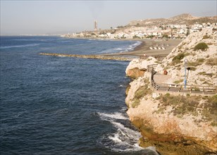 Coastline with breakwater groyne, waves and beach at La Cala del Moral, Malaga, Spain, Europe