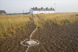 Line of white shells crossing beach to houses at the coastal hamlet of Shingle Street, North Sea