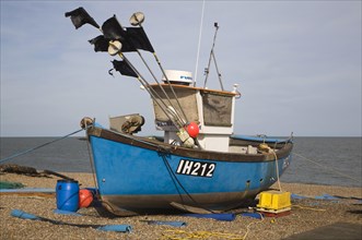 Fishing boats and equipment on the shingle beach at Aldeburgh, Suffolk, England, United Kingdom,