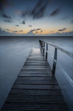 Long exposure of a jetty at the North Sea at high tide, high photograph, sunset, landscape