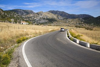 Vehicle driving around corner in rural road in Sierra de Grazalema natural park, Cadiz province,