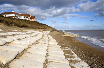 Coastal defences normally covered by shingle exposed by winter storms at Thorpeness, Suffolk,
