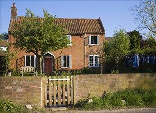 Property released picture of red brick detached house viewed from front wall and gate, Shottisham,
