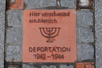 Memorial stone on a pavement at Magdeburg Central Station with an inscription commemorating the