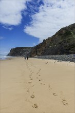 Beach walk in front of rocky beach landscape, walk, tracks, footprints, path, hike, hike, beach,