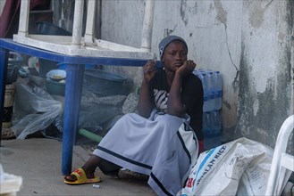 Woman selling water. Street scene in Abuja, Nigeria, 05/02/2024, Africa