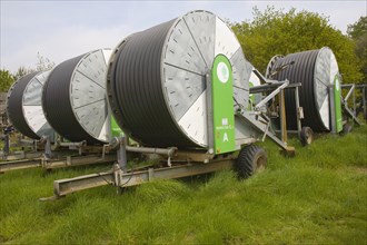Rainstar irrigation crop sprayers stored in farm yard, Suffolk, England, United Kingdom, Europe