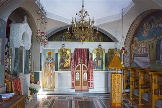 Interior view of a small church with richly decorated iconostasis and frescoes, Monastery of St