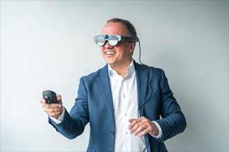 Man using mixed reality goggles and remote control in the office