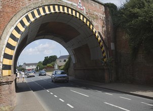 Warning paint over arch of low road bridge in Lawford, near Manningtree, Essex, England, United