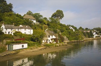 Pretty houses line the banks of river at Helford village, Cornwall, England, United Kingdom, Europe