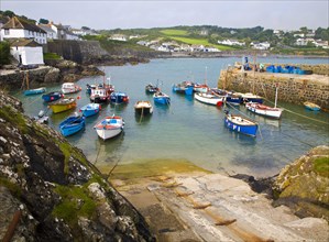 Small fishing boats in the harbour at the village of Coverack on the Lizard peninsula, Cornwall,