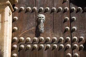 Old metal door-knocker of historic house in the old city of Ronda, Spain, Europe